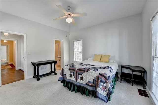 a bedroom with a bed a table and painting