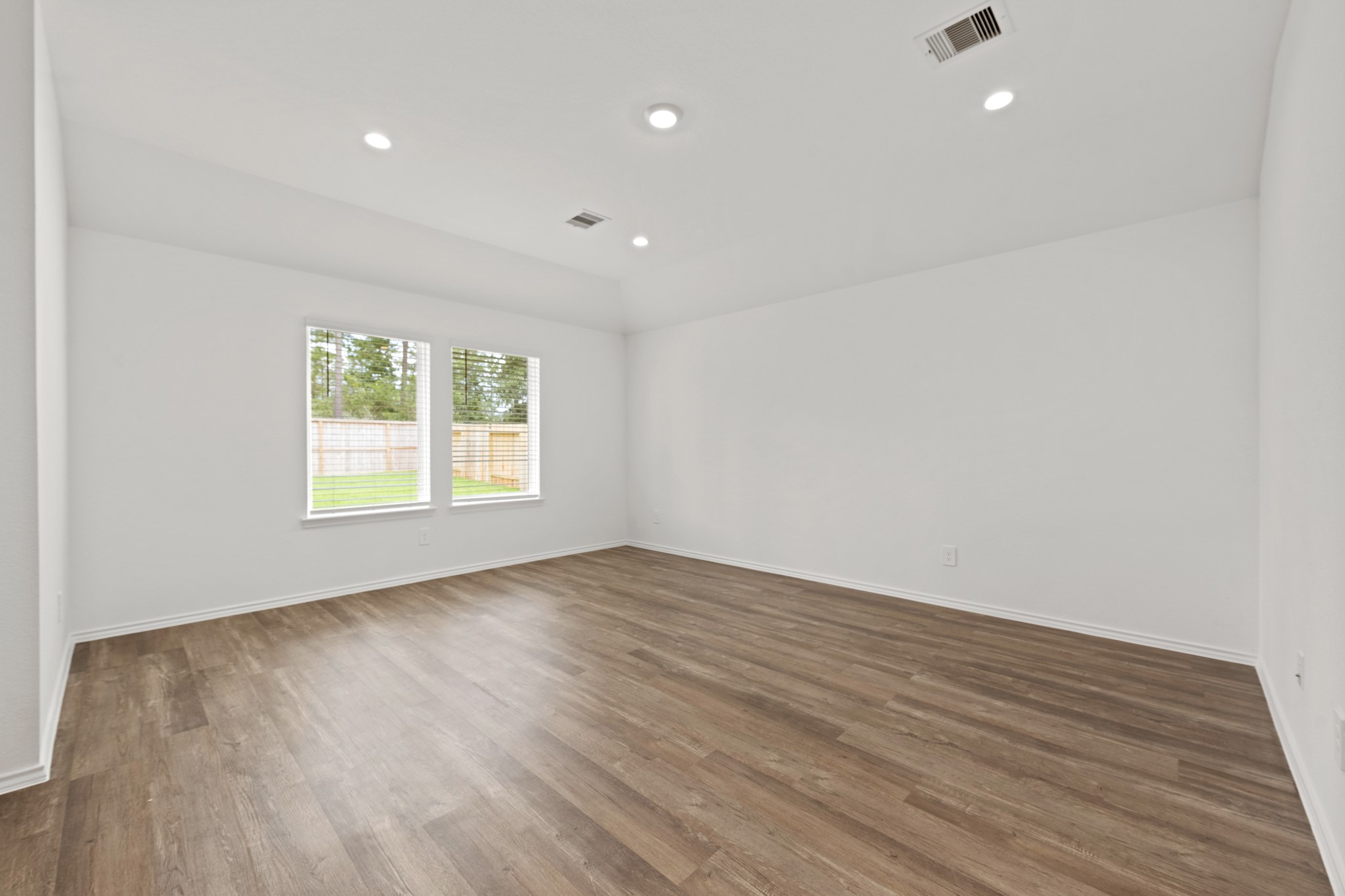 14270 Moon Flower Drive Splendora, TX 77372 - Photo 2 of 13 an empty room with wooden floor and windows
