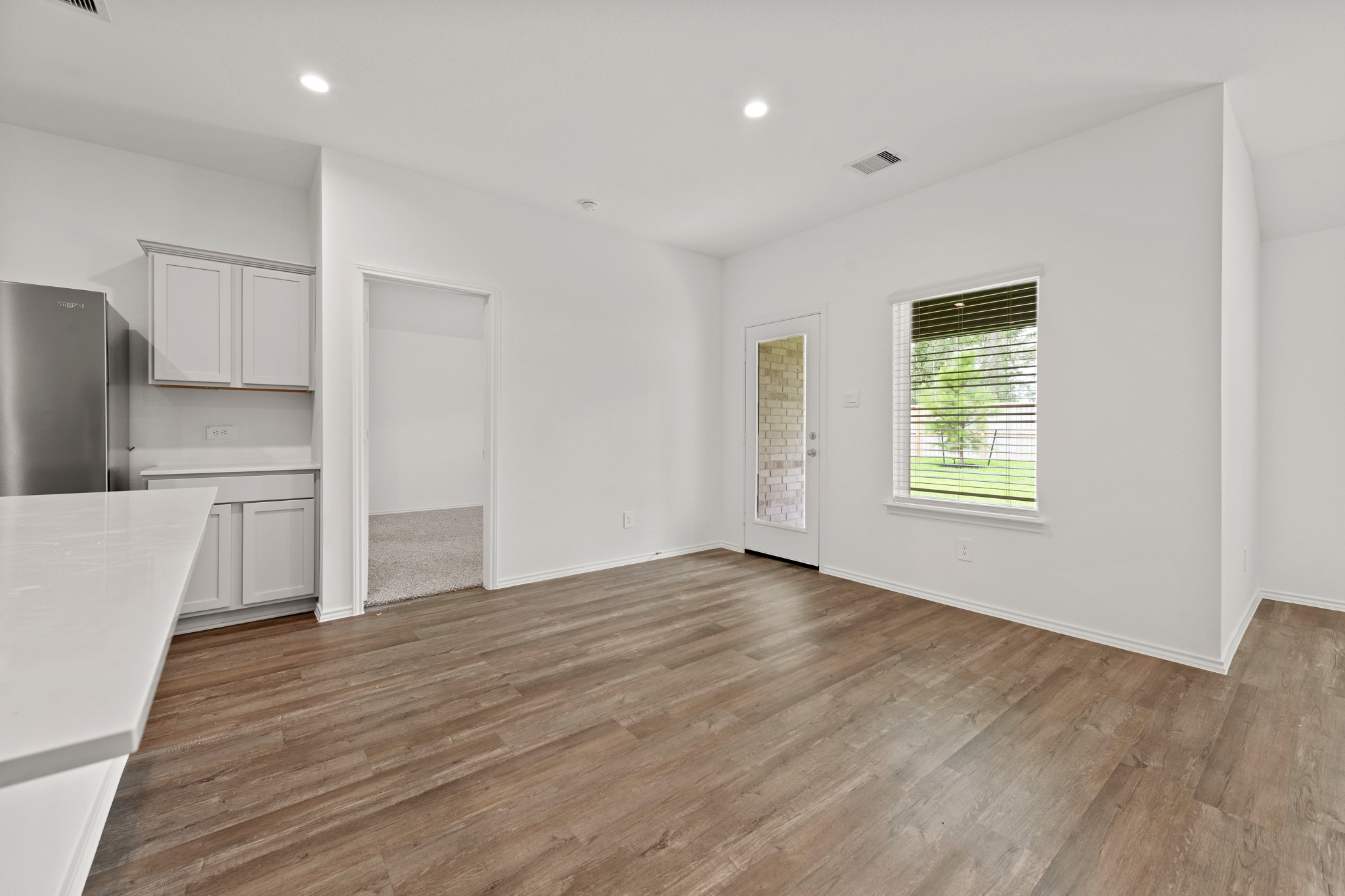 14270 Moon Flower Drive Splendora, TX 77372 - Photo 3 of 13 a view of a kitchen with wooden floor electronic appliances and window