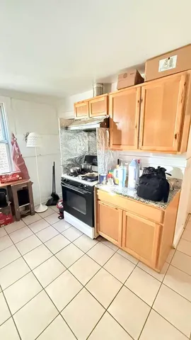 a kitchen with stainless steel appliances a stove a sink and a refrigerator