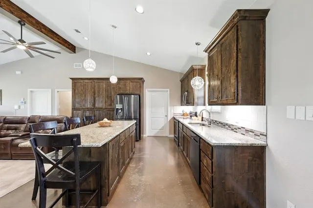 a large kitchen with a table and chairs
