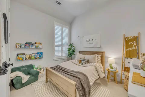 a bedroom with a bed and a window