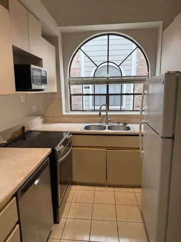 a kitchen with a stove a sink and a microwave