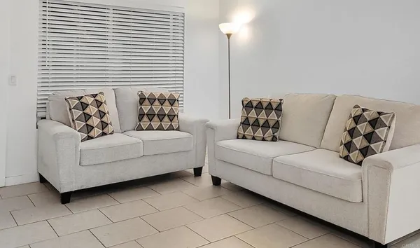 a living room with furniture and a large window