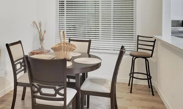 a view of a dining room with furniture and wooden floor