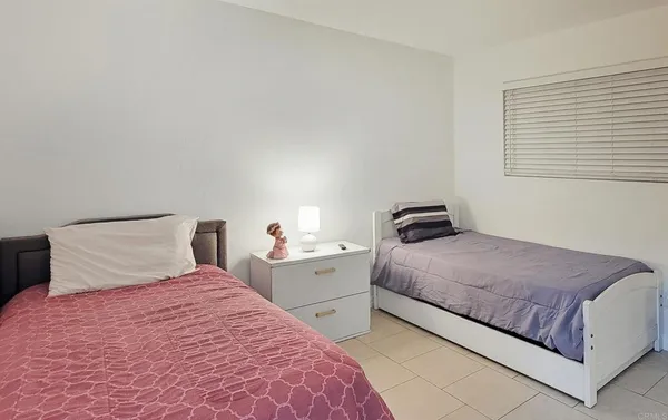 a bedroom with a bed and a lamp