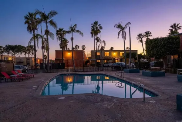 a view of a swimming pool with a table and chairs