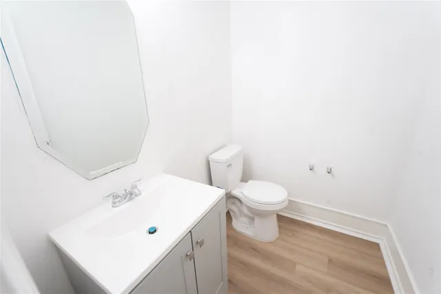 a bathroom with a white toilet sitting next to a white sink