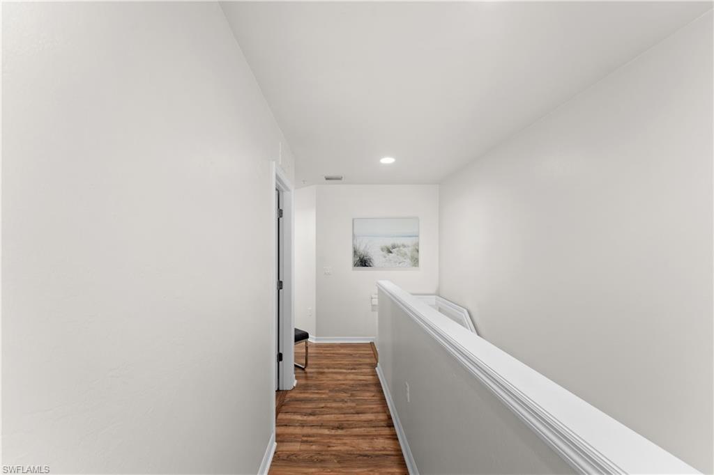 16191 Ravina Way, Unit 23 Naples, FL 34110 - Photo 9 of 29 Hall featuring dark hardwood / wood-style flooring