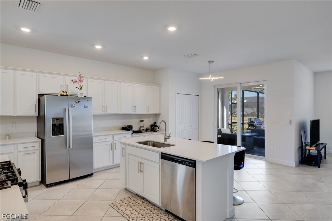 14961 Anchorage Road Punta Gorda, FL 33982 - Photo 11 of 32 a kitchen that has a lot of white cabinets and stainless steel appliances