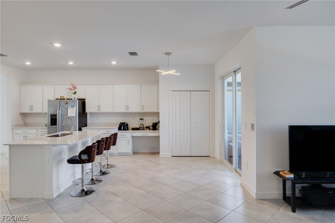 14961 Anchorage Road Punta Gorda, FL 33982 - Photo 12 of 32 a view of kitchen with refrigerator microwave and cabinets