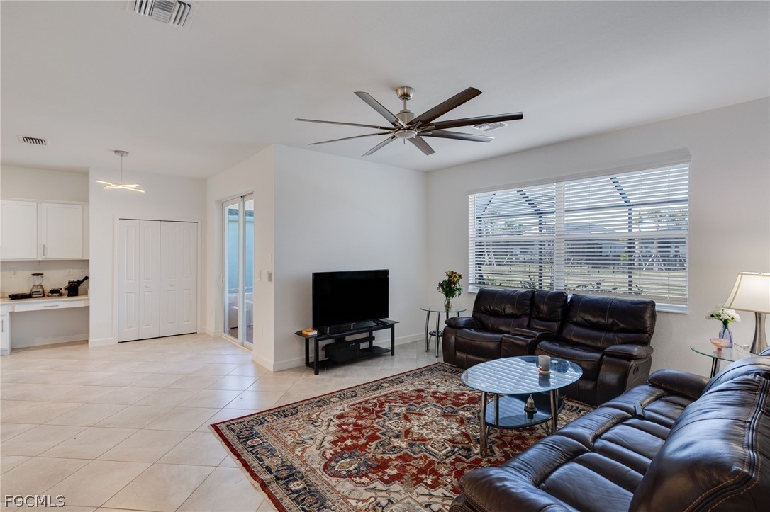 14961 Anchorage Road Punta Gorda, FL 33982 - Photo 14 of 32 a living room with furniture a flat screen tv and a large window