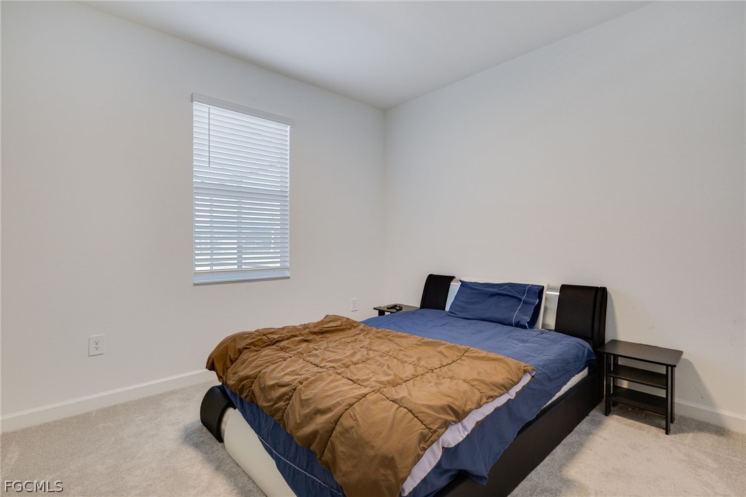 14961 Anchorage Road Punta Gorda, FL 33982 - Photo 17 of 32 a bedroom with a bed and window
