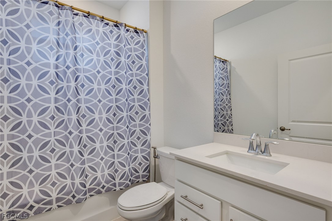 14961 Anchorage Road Punta Gorda, FL 33982 - Photo 18 of 32 a bathroom with a granite countertop toilet sink and mirror