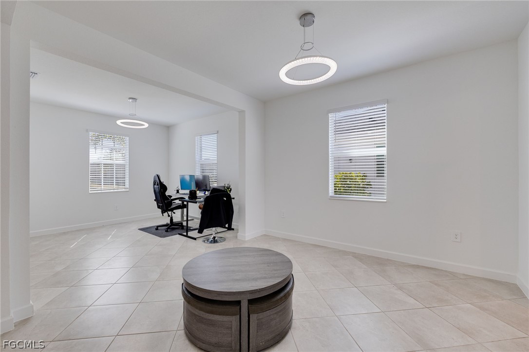 14961 Anchorage Road Punta Gorda, FL 33982 - Photo 19 of 32 a room with a table chairs and a chandelier