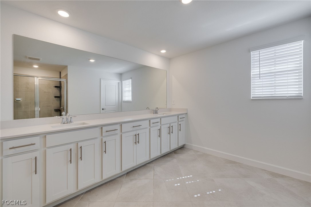14961 Anchorage Road Punta Gorda, FL 33982 - Photo 23 of 32 a spacious bathroom with 2 sink tub and a mirror