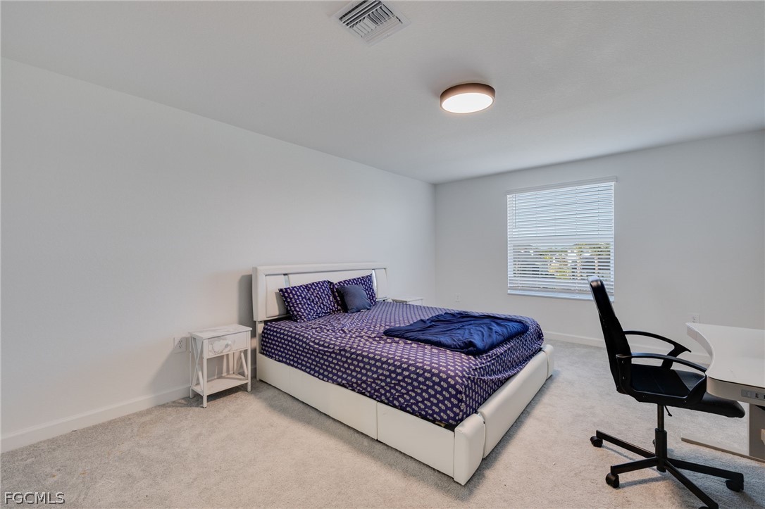 14961 Anchorage Road Punta Gorda, FL 33982 - Photo 24 of 32 a bedroom with a bed and a window