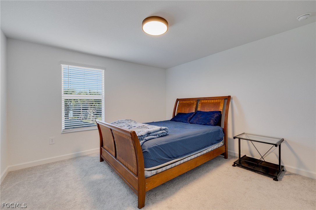 14961 Anchorage Road Punta Gorda, FL 33982 - Photo 25 of 32 a bedroom with a bed and window