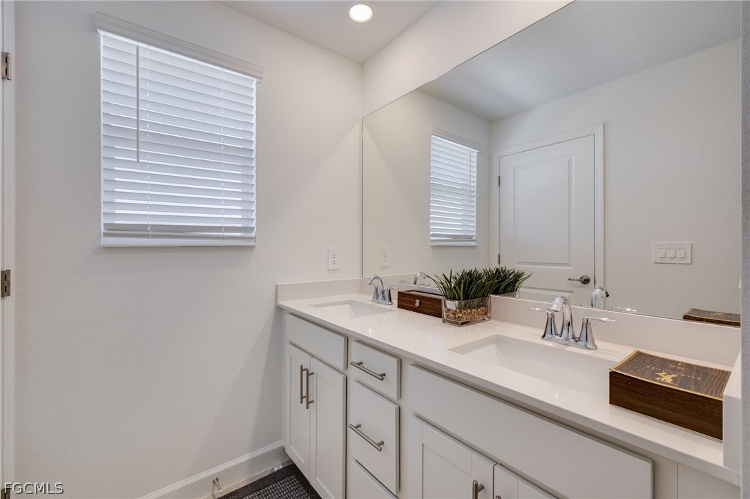 14961 Anchorage Road Punta Gorda, FL 33982 - Photo 26 of 32 a bathroom with a sink and a mirror