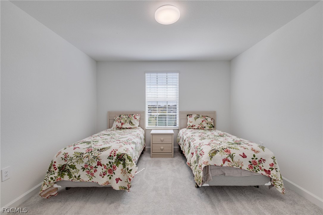 14961 Anchorage Road Punta Gorda, FL 33982 - Photo 27 of 32 a bedroom with two beds and a window