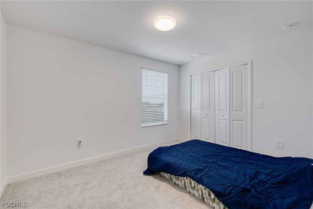 14961 Anchorage Road Punta Gorda, FL 33982 - Photo 28 of 32 a bedroom with a bed and a window