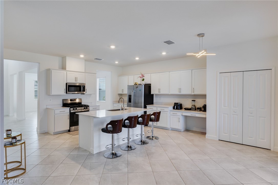 14961 Anchorage Road Punta Gorda, FL 33982 - Photo 9 of 32 a kitchen with stainless steel appliances kitchen island granite countertop a sink and cabinets