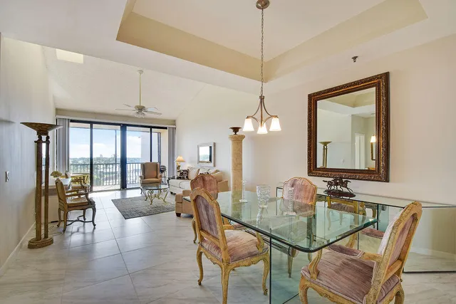a dining room with furniture a chandelier and window