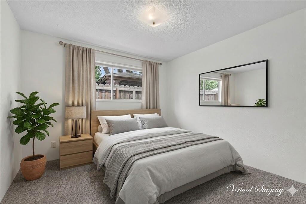 415 Sutter Avenue Medford, OR 97504 - Photo 18 of 28 a bedroom with a bed and a potted plant