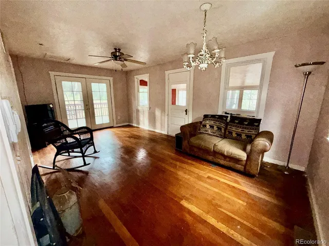 a living room with furniture and a chandelier