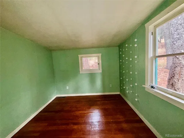 a view of a room with window and wooden floor