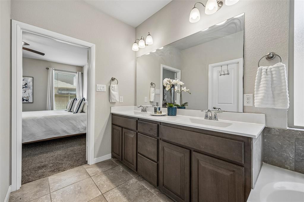 2508 Red Draw Road Fort Worth, TX 76177 - Photo 22 of 38 Double vanity with wood-finish cabinetry, white countertop, and integrated sinks