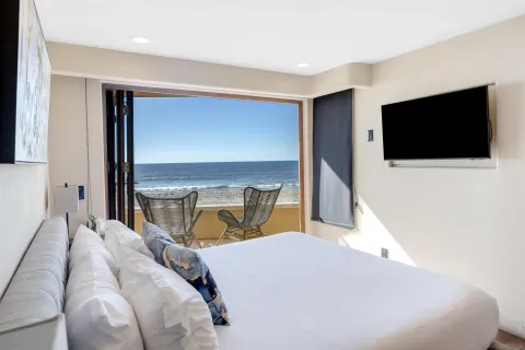 a bedroom with a bed and a flat screen tv