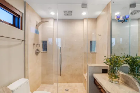 a bathroom with a sink shower and a mirror