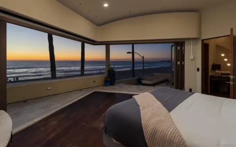 a bedroom with a bed and large window