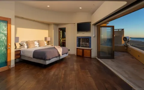 a bedroom with a bed and large window