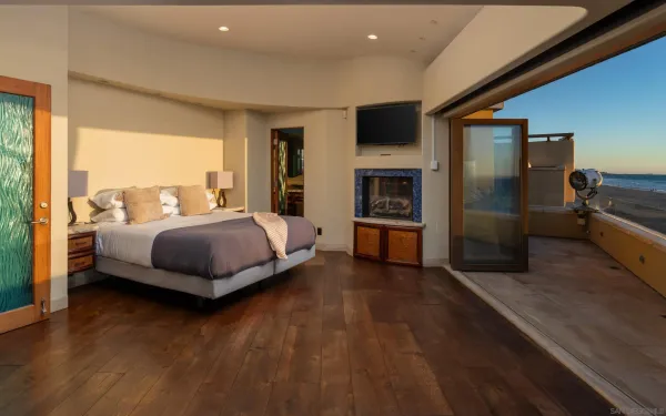 a bedroom with a bed and large window