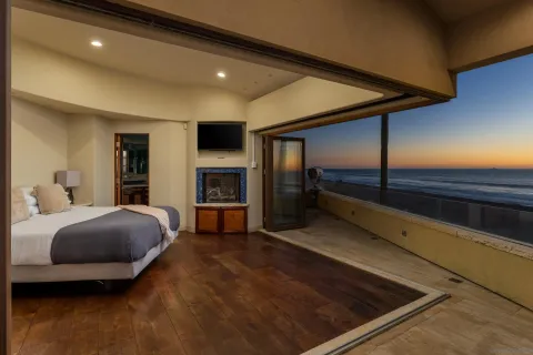 a spacious bedroom with a bed and a fireplace