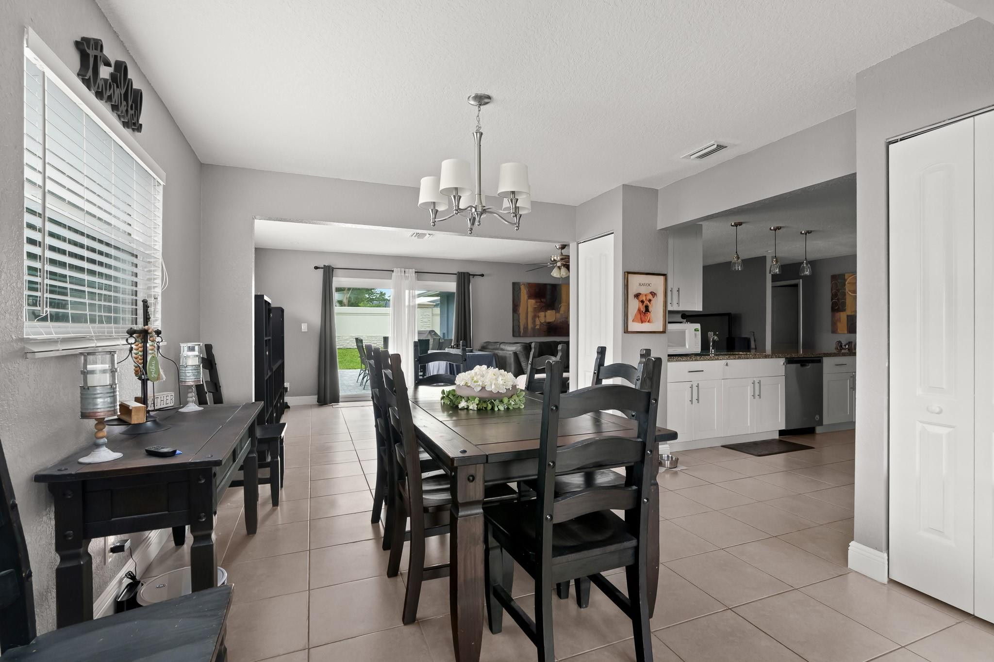 9402 Northwest 70th Street Tamarac, FL 33321 - Photo 15 of 60 a view of a dining room with furniture and a chandelier