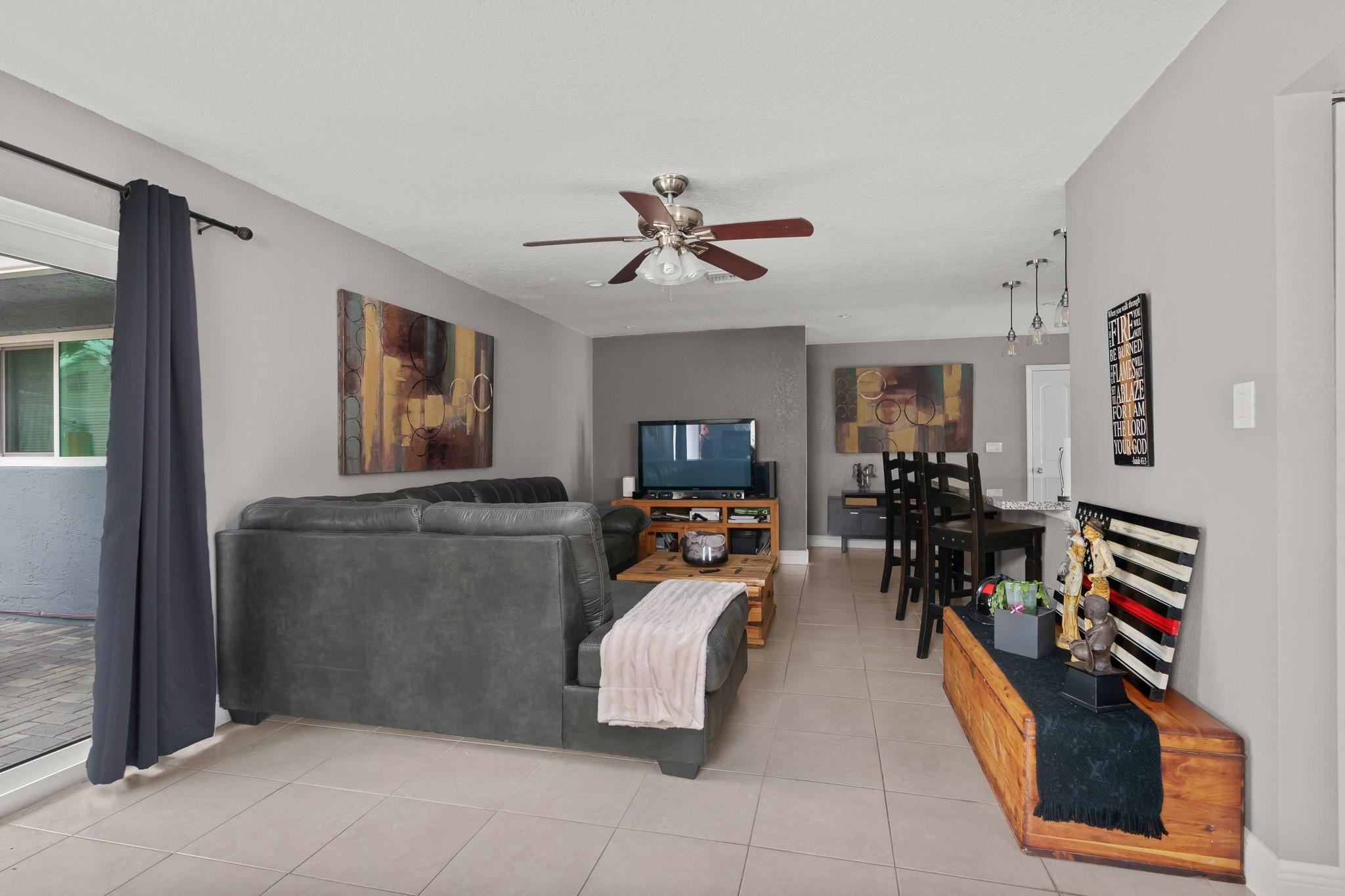 9402 Northwest 70th Street Tamarac, FL 33321 - Photo 21 of 60 a living room with furniture and a flat screen tv