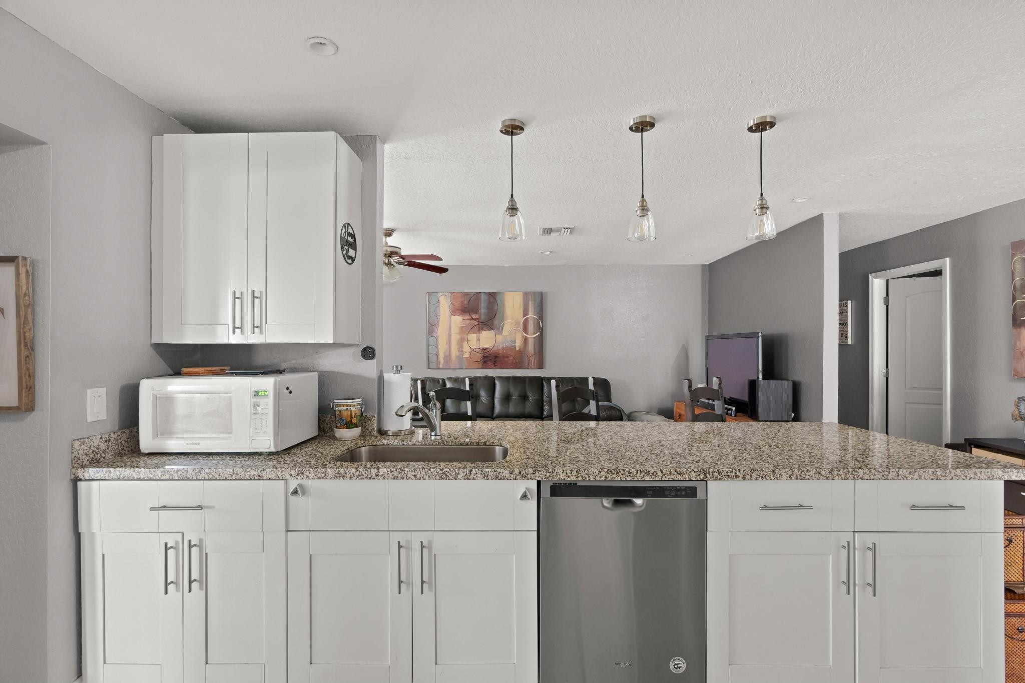 9402 Northwest 70th Street Tamarac, FL 33321 - Photo 29 of 60 a kitchen with granite countertop a sink cabinets and window