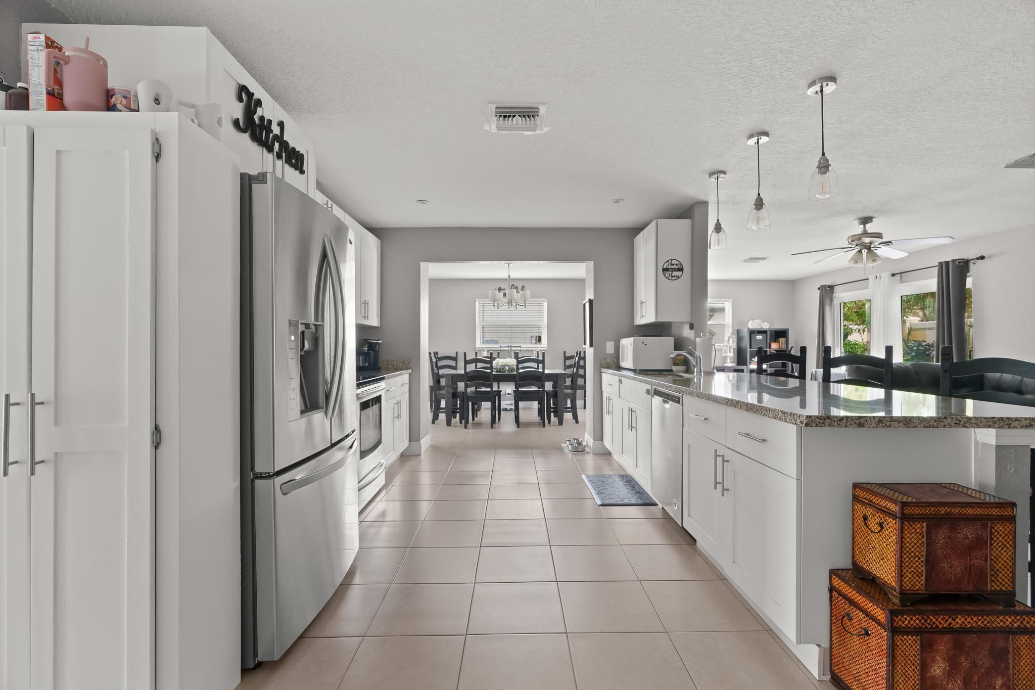 9402 Northwest 70th Street Tamarac, FL 33321 - Photo 30 of 60 a kitchen with stainless steel appliances granite countertop a refrigerator and a stove top oven