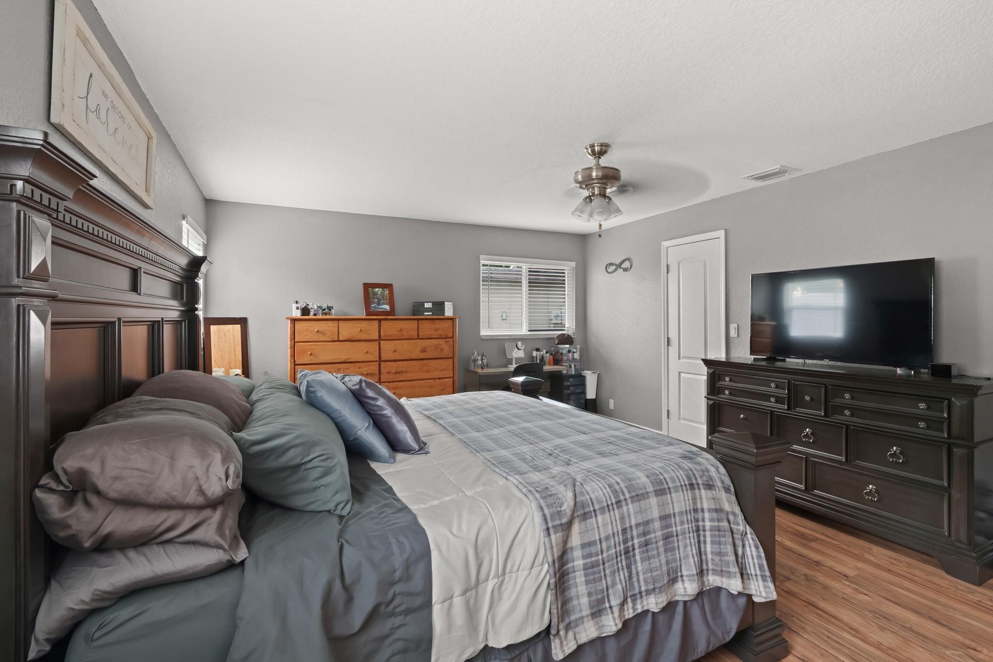 9402 Northwest 70th Street Tamarac, FL 33321 - Photo 33 of 60 a bedroom with a bed and a flat screen tv