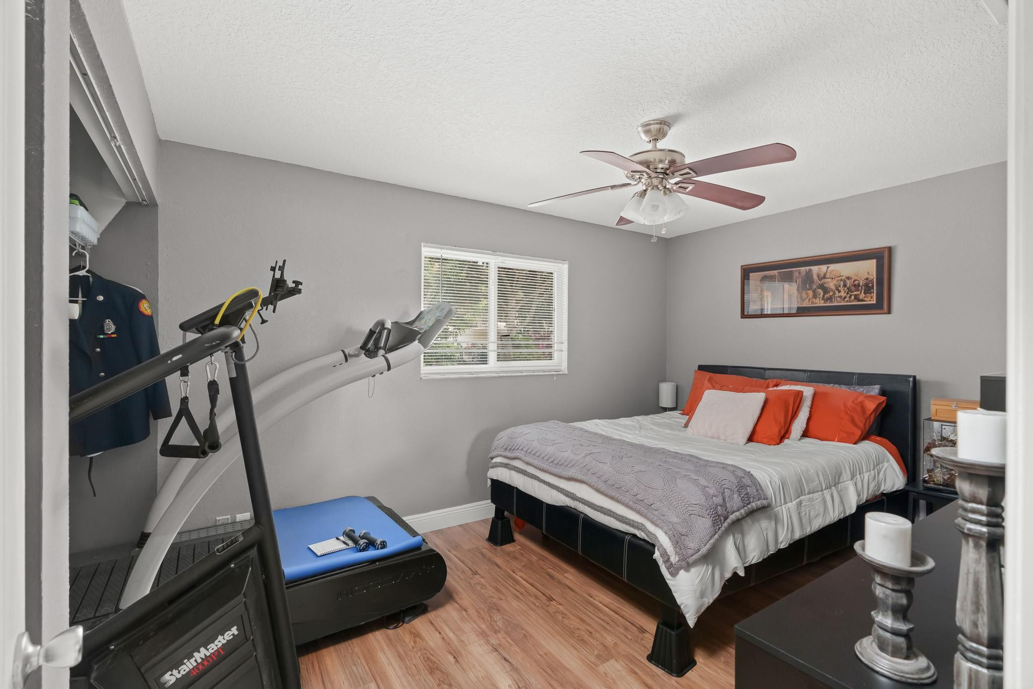 9402 Northwest 70th Street Tamarac, FL 33321 - Photo 38 of 60 a bedroom with a bed and a ceiling fan