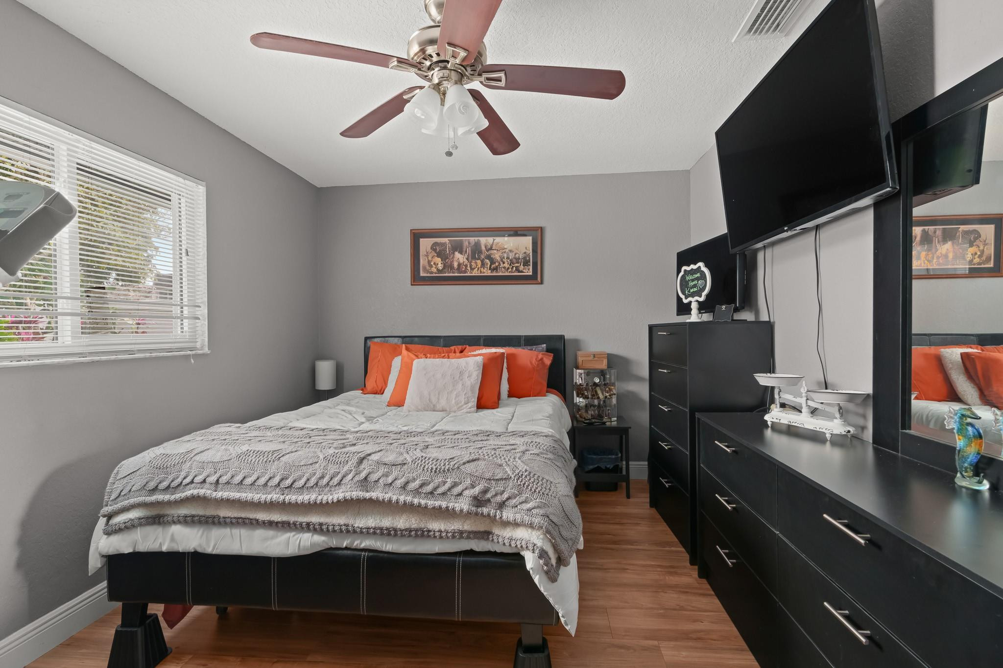9402 Northwest 70th Street Tamarac, FL 33321 - Photo 39 of 60 a bedroom with a bed and a flat tv screen on the dresser