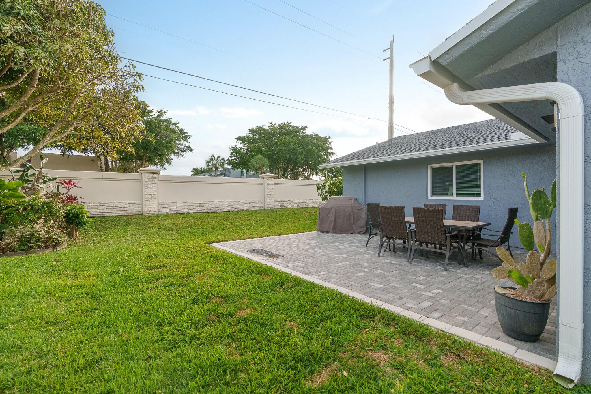 9402 Northwest 70th Street Tamarac, FL 33321 - Photo 48 of 60 a view of backyard with seating space and trees