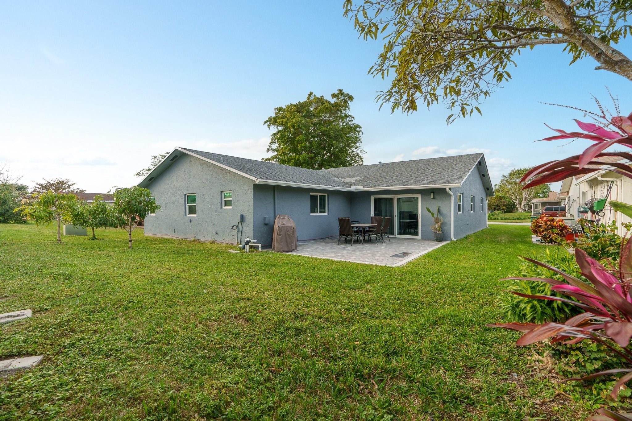 9402 Northwest 70th Street Tamarac, FL 33321 - Photo 49 of 60 a front view of house with yard and green space