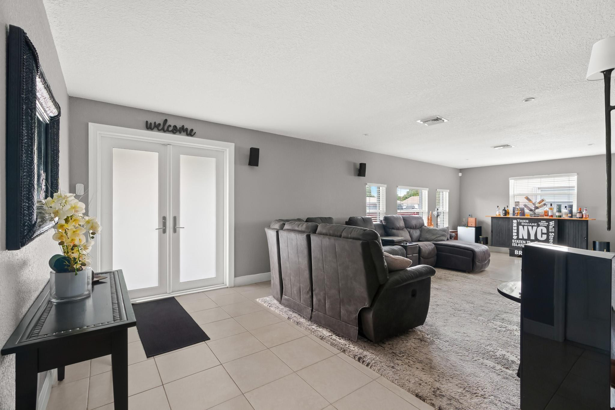 9402 Northwest 70th Street Tamarac, FL 33321 - Photo 6 of 60 a living room with furniture a chandelier and a dining room