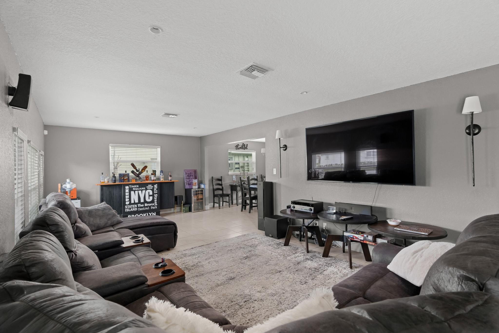9402 Northwest 70th Street Tamarac, FL 33321 - Photo 9 of 60 a living room with furniture and a flat screen tv