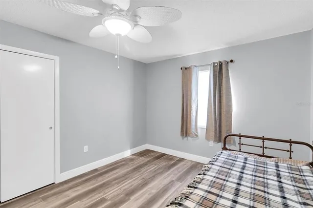 a view of a room with wooden floor and fan