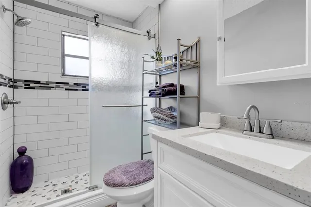 a bathroom with a sink toilet and shower